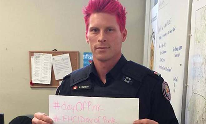 A photo of a police officer with pink hair.