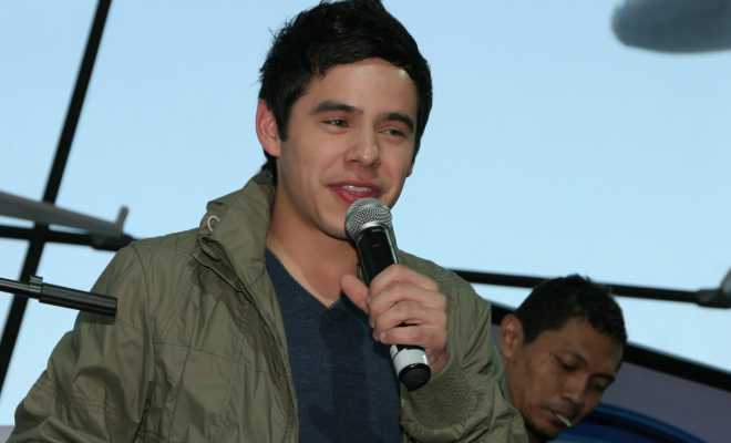 A photo of David Archuleta singing.