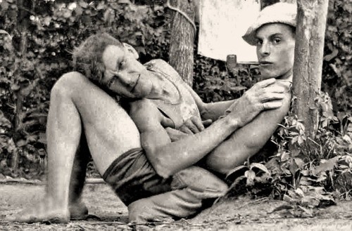 A vintage photo of a gay couple cuddling.