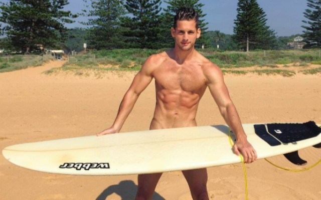 This is a photo of model Max Emerson about to go surfing.