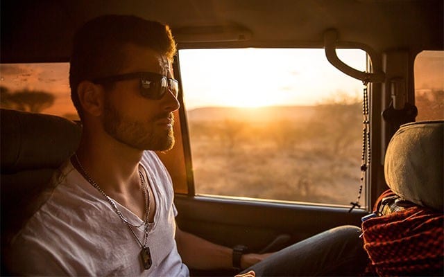 This is a photo of a bisexual man riding in a car.