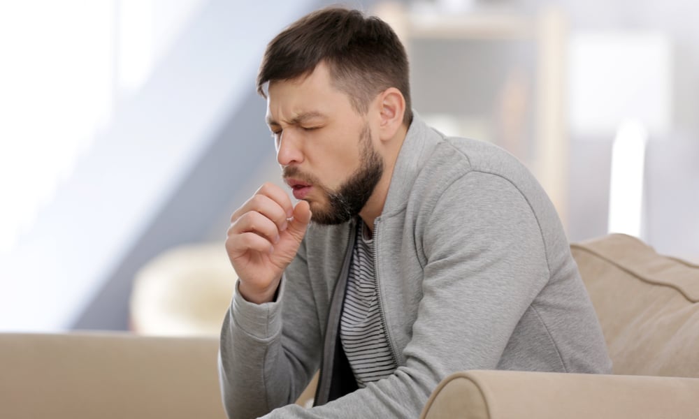 Young man coughing