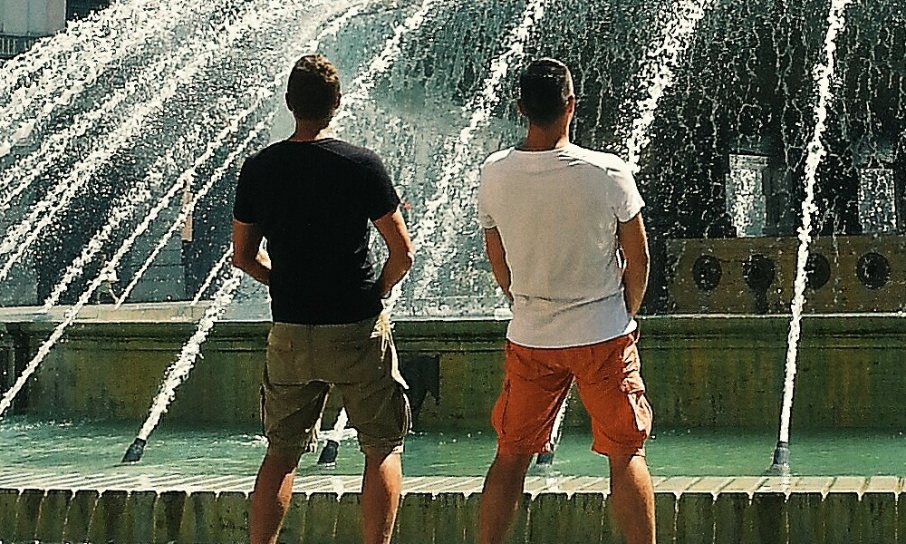 Man standing by a fountain