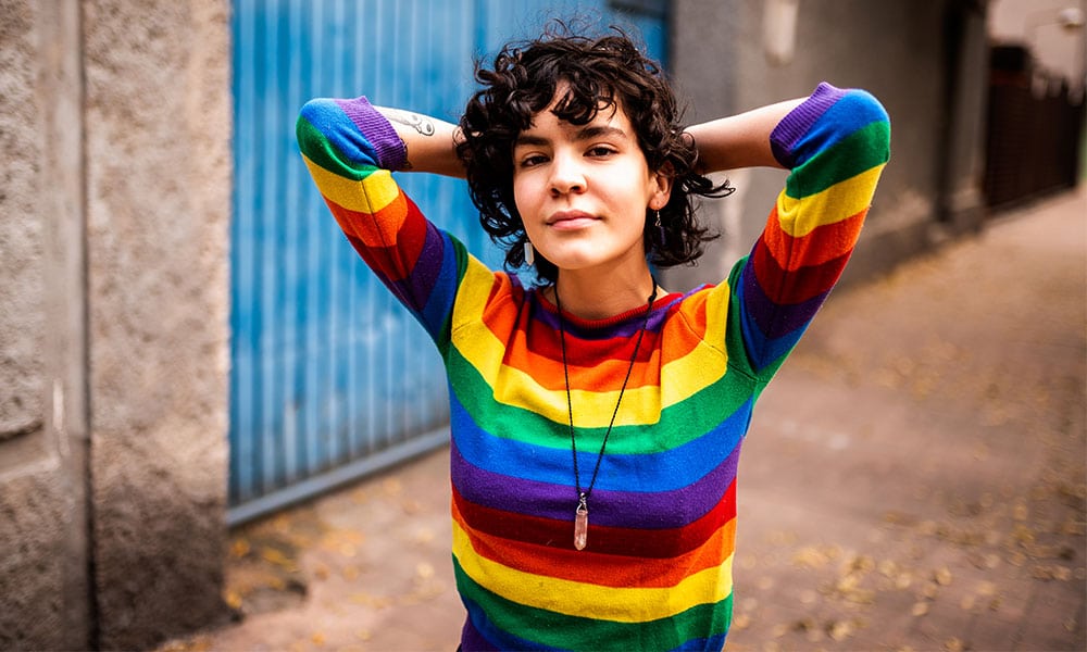 Portrait of a smiling queer Mexican woman.