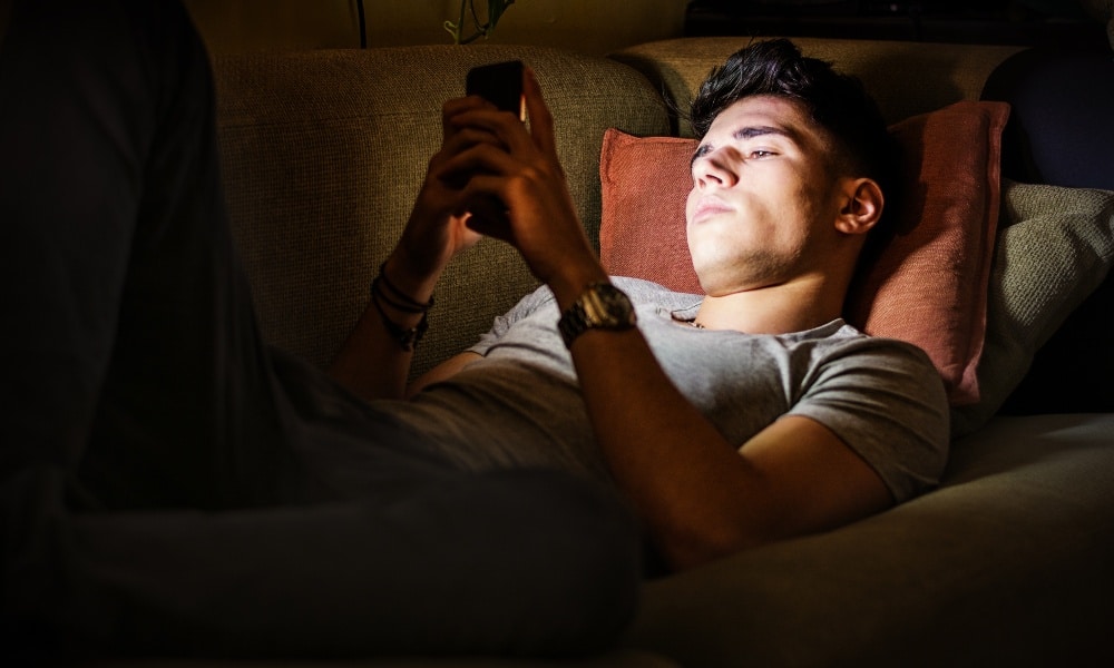 Man looking at the screen of a smart phone