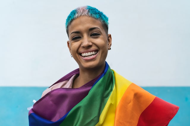 young bisexual woman holding pride flag