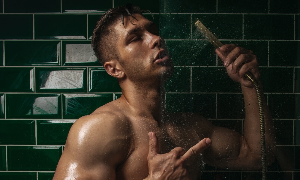 Cocky man taking a shower at the gym