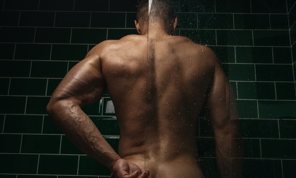 Cocky man taking a shower at the gym