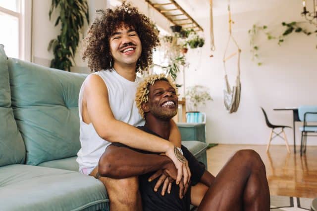 Queer couple embracing each other indoors