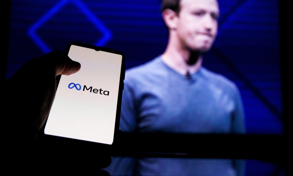 Kaunas, Lithuania 2022 - April 14: Meta logo on screen and Mark Zuckerberg is a Chief Executive Officer of Metaverse in background