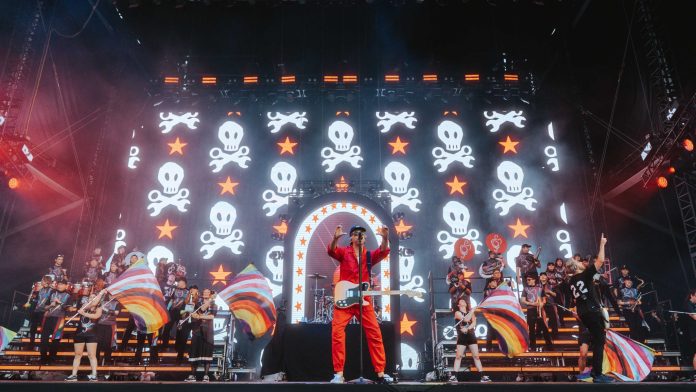 All Time Low made a powerful Pride Month statement at Warped Tour DC with an LGBTQ+ marching band and cheer squad. All Time Low made a powerful Pride Month statement at Warped Tour DC with an LGBTQ+ marching band and cheer squad.
