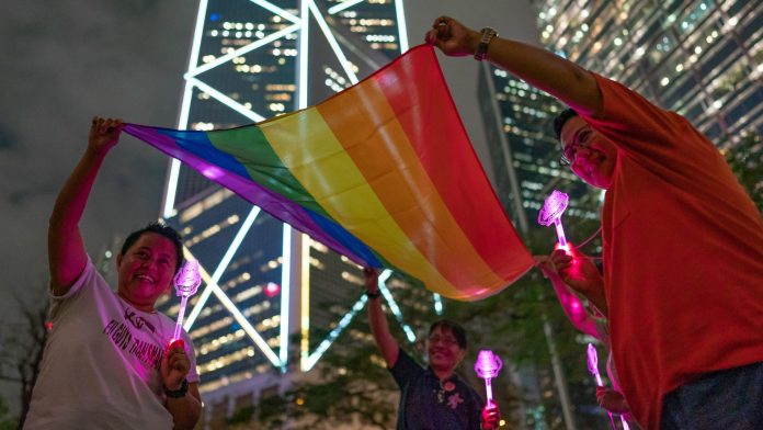 Hong Kongers Mark International Day Against Homophobia, Transphobia and Biphobia LGBT supporters hold a rainbow flag as they take part in a gathering for International Day Against Homophobia on May 17, 2019 in Hong Kong, China. Taiwan's parliament became the first in Asia to legalize same-sex marriage after lawmakers voted on Friday to allow same-sex couples full legal marriage rights, including areas in taxes, insurance and child custody.