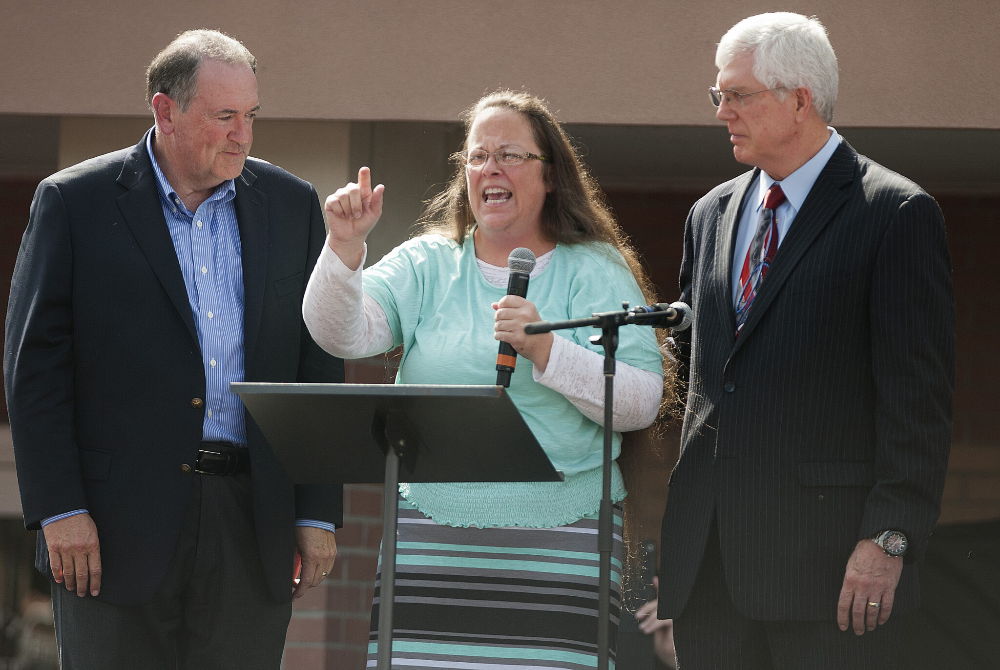 Rowan County Clerk of Courts Kim Davis speaks next to her attorney Mat Staver (R) and Republican presidential candidate Mike Huckabee (L) in front of the Carter County Detention Center on September 8, 2015 in Grayson, Kentucky. Davis was ordered to jail last week for contempt of court after refusing a court order to issue marriage licenses to same-sex couples.