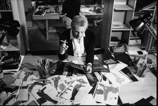 Italian fashion designer Giorgio Armani, born in Piacenza in 1935, examines drawings for new designs.
