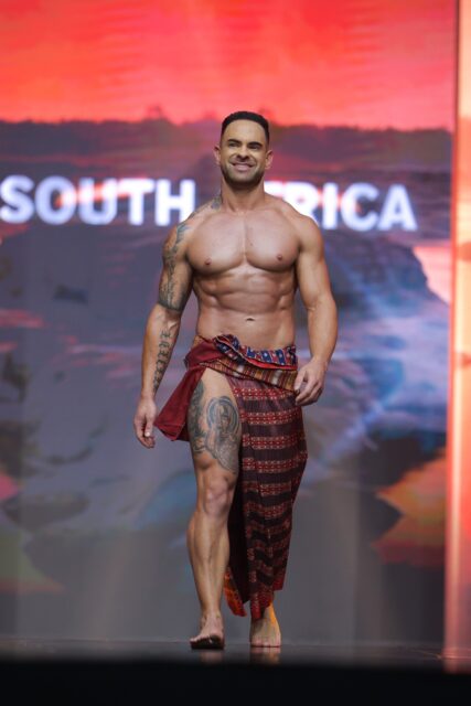 The men of Mister Global 2025 walk the stage in traditional Thai attire.