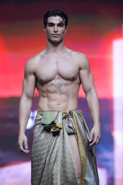 The men of Mister Global 2025 walk the stage in traditional Thai attire.