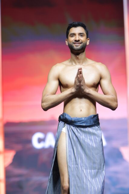 The men of Mister Global 2025 walk the stage in traditional Thai attire.