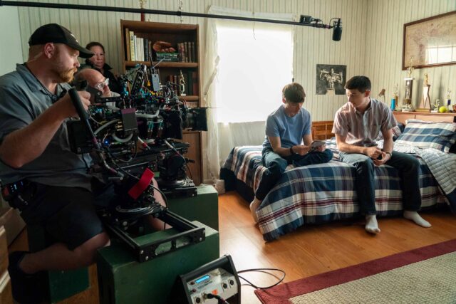 BOOTS. (L to R) Miles Heizer as Cameron Cope and Liam Oh as Ray McAffey behind the scenes of Episode 101 of Boots. Cr. Alfonso "Pompo" Bresciani/Netflix © 2023