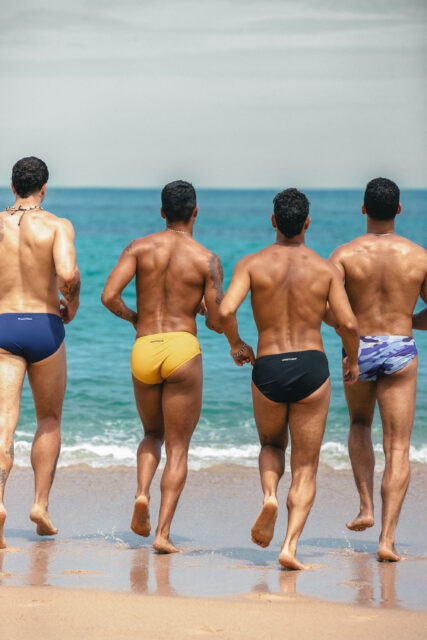 Sniffies launched a new Summer Swim Collection featuring swim briefs, crop tanks, trunks, and towels inspired by spontaneous hookups and beach days.