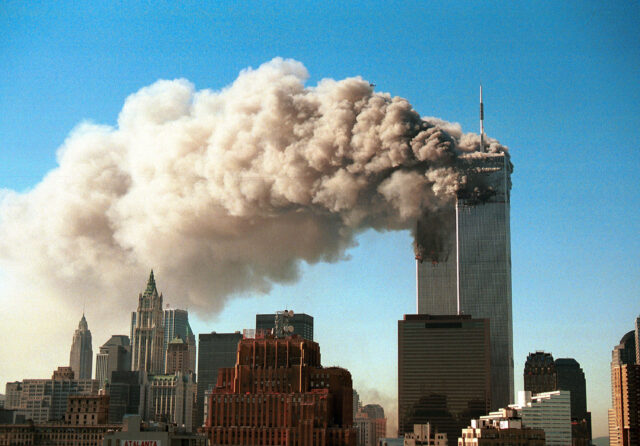 Smoke pours from the twin towers of the World Trade Center after they were hit by two hijacked airliners in a terrorist attack September 11, 2001 in New York City.  