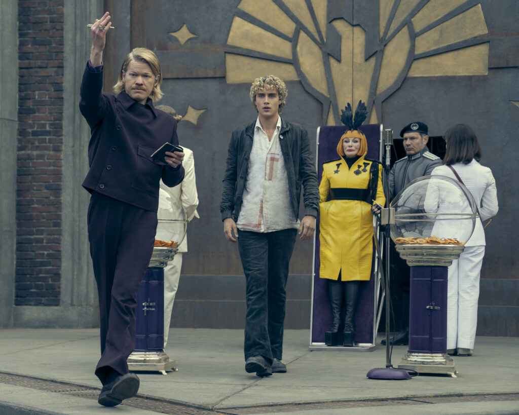 Jesse Plemons as Plutarch Heavensbee and Joseph Zada as Haymitch Abernathy in The Hunger Games: Sunrise on the Reaping. Photo Credit: Murray Close/Lionsgate